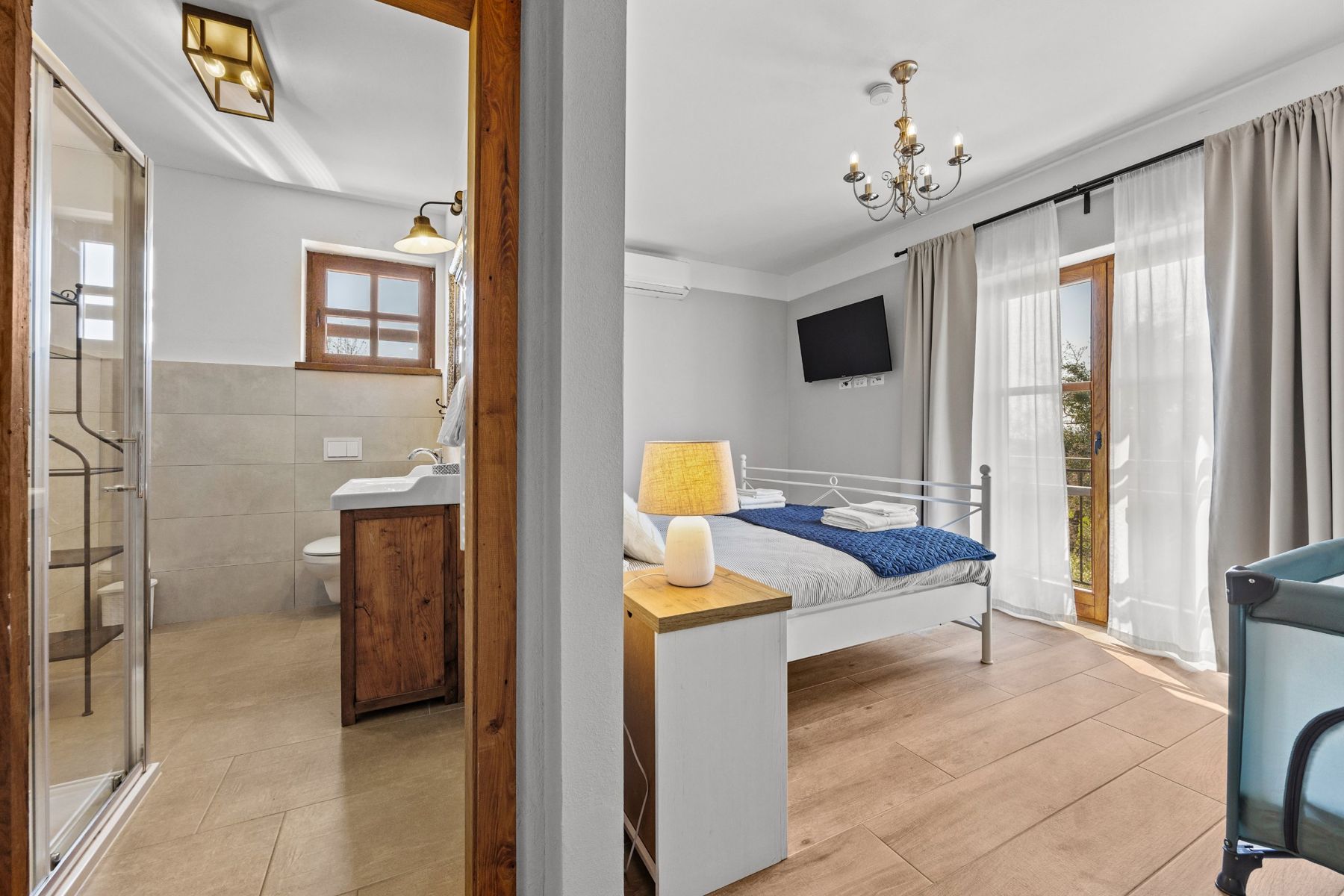 A bedroom seen next to its ensuite bathroom